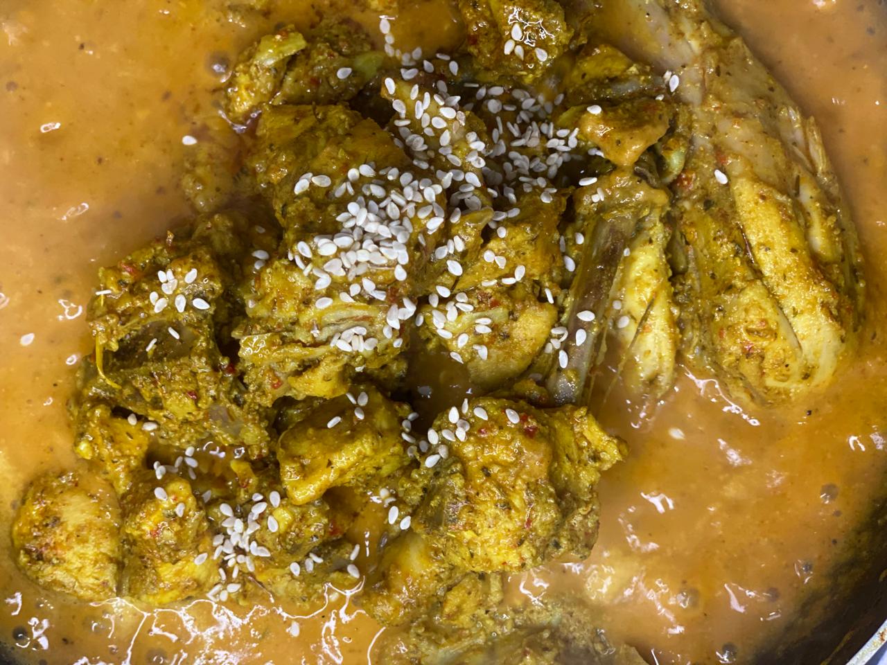 adding chicken in curry