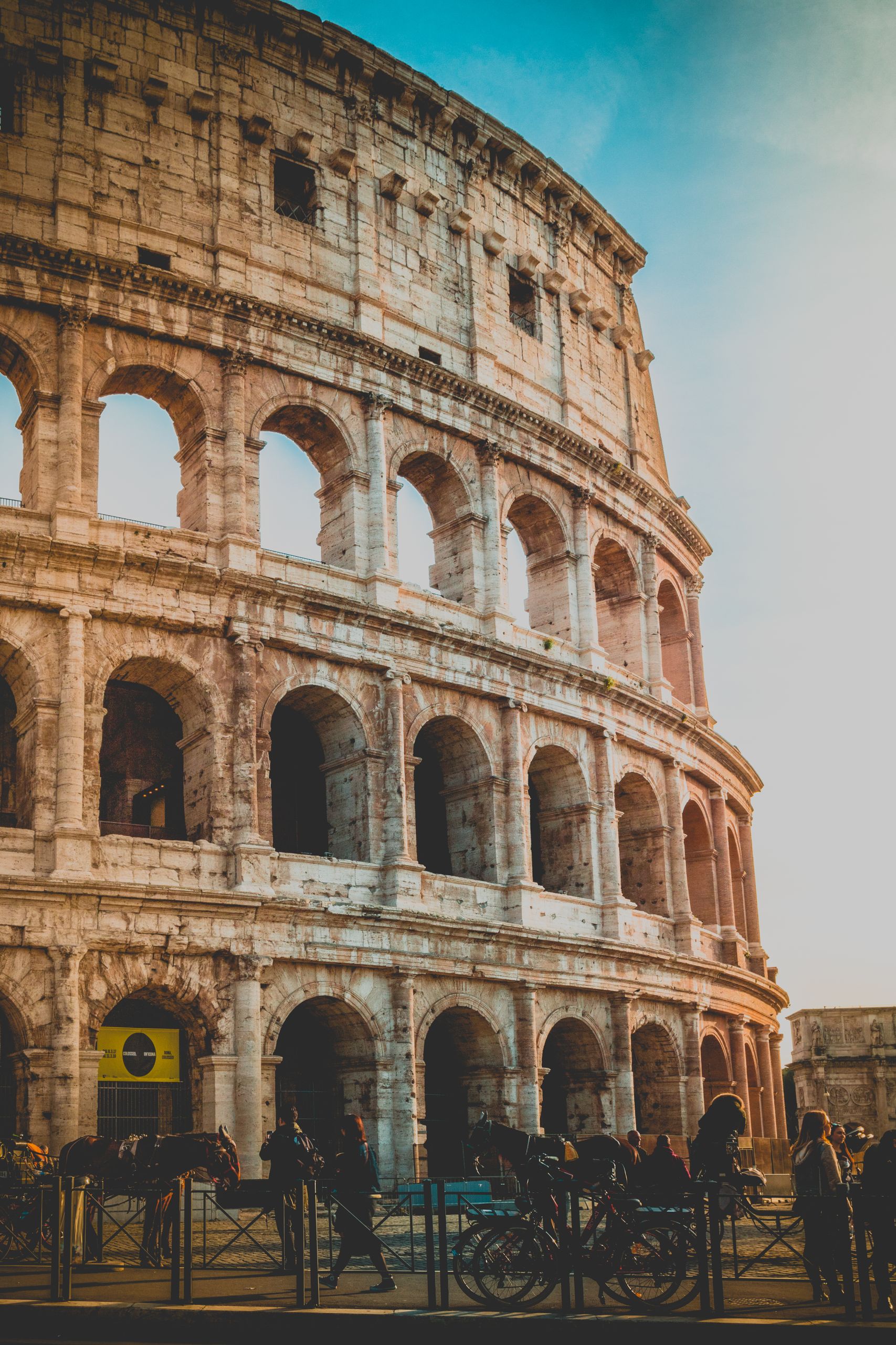 Sunset view of Rome's iconic Colosseum, a masterpiece of ancient architecture.
